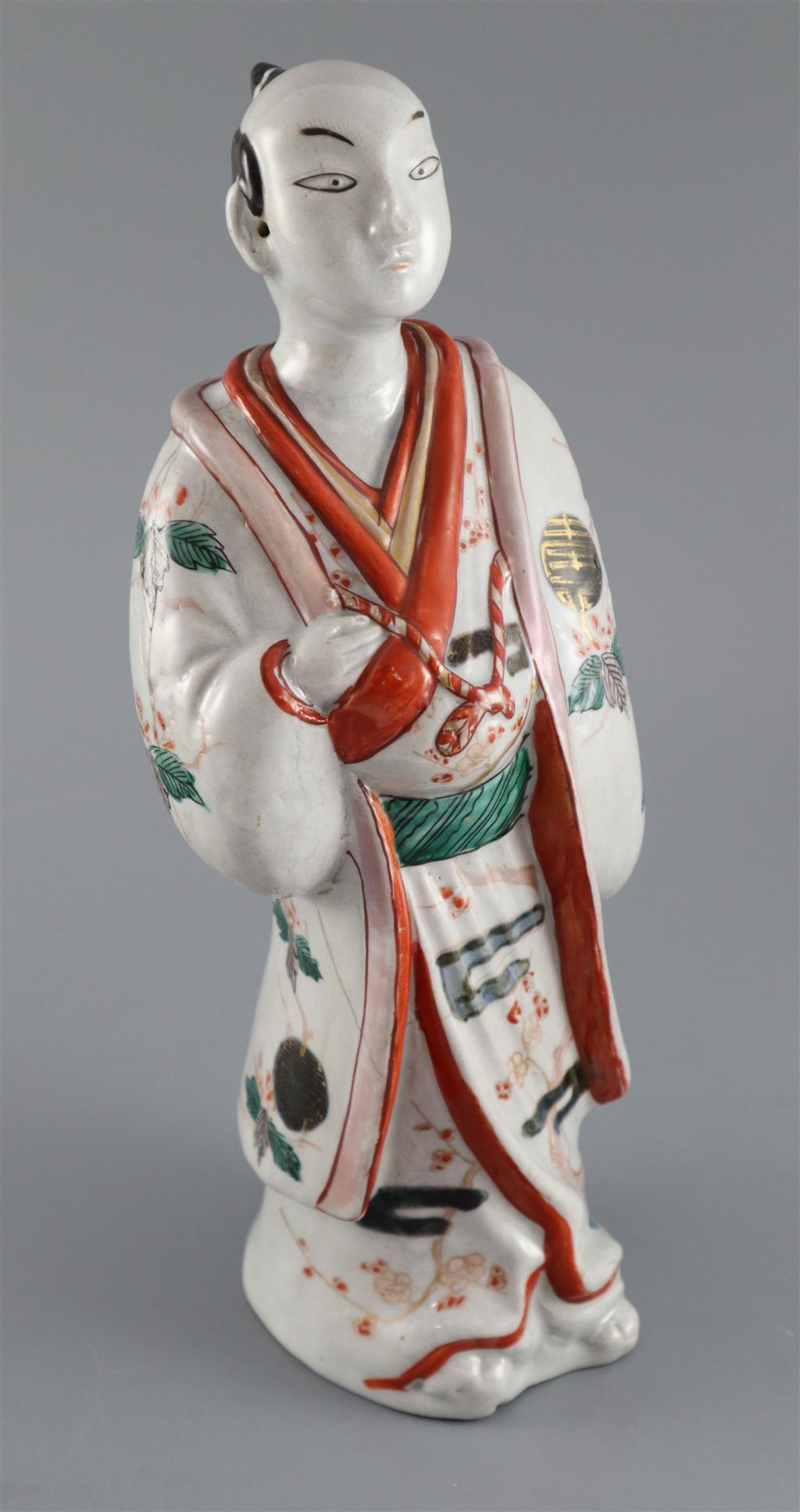 A Japanese porcelain figure of a man dressed in a kimono, Hizen, c.1690-1720, 31.5cm high